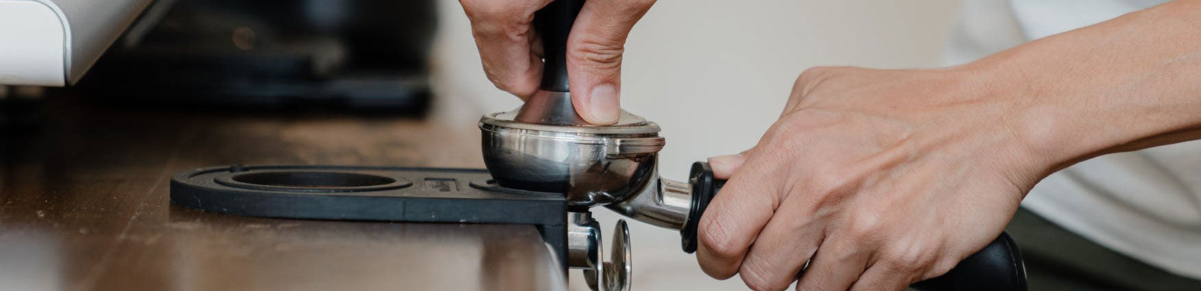 barista tamping espresso coffee
