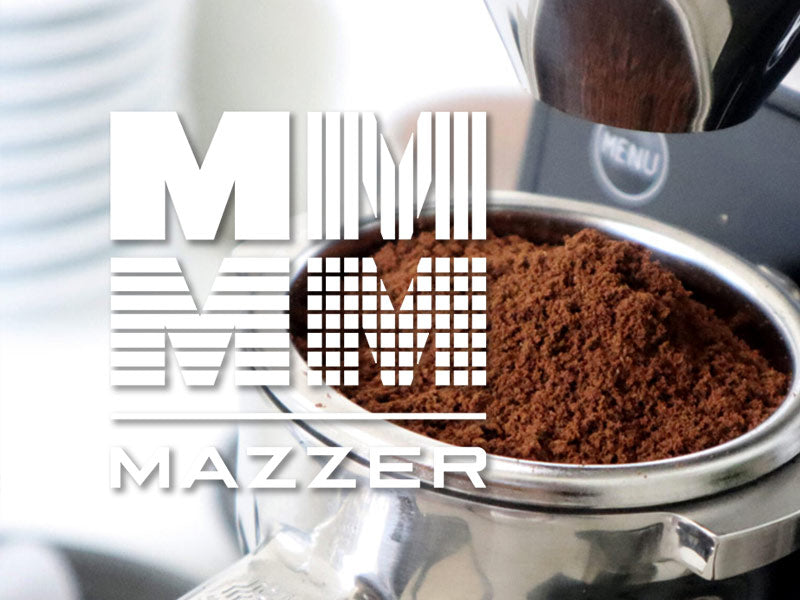mazzer coffee grinder logo with coffee grinds in portafilter